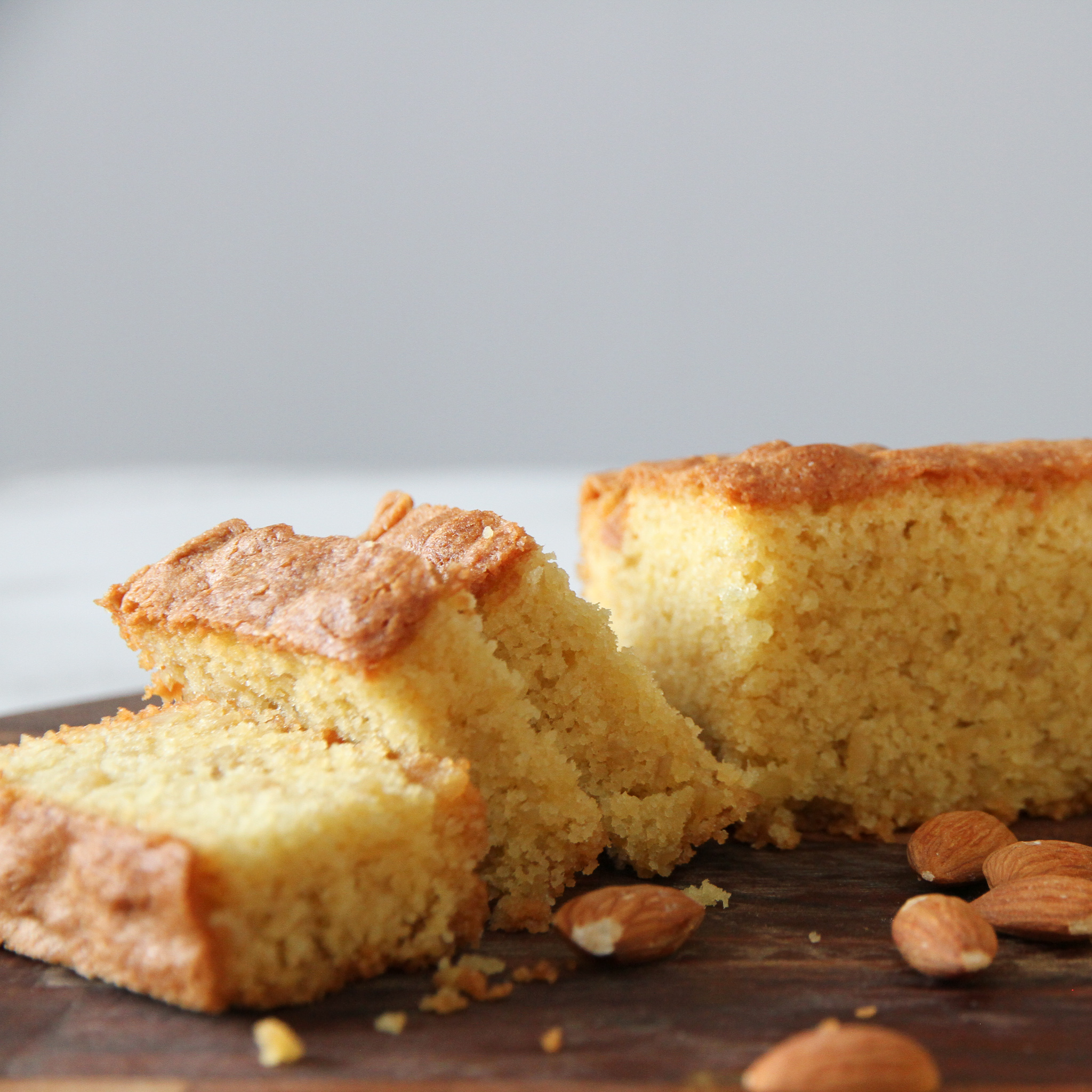 A sugee cake, sliced, with almonds
